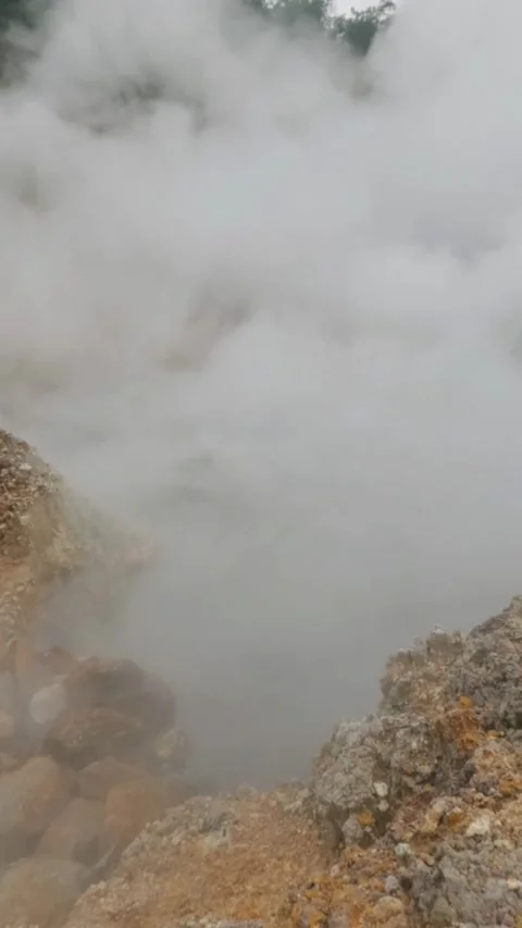 Vertical Slow motion activity of an active crater that emits hot steam sulfur Stock Footage 319908861