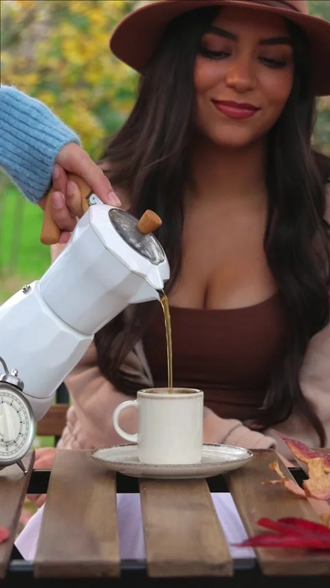 Vertical Slow motion autumn coffee pouring with smiling latin woman in hat Stock Footage 294187132