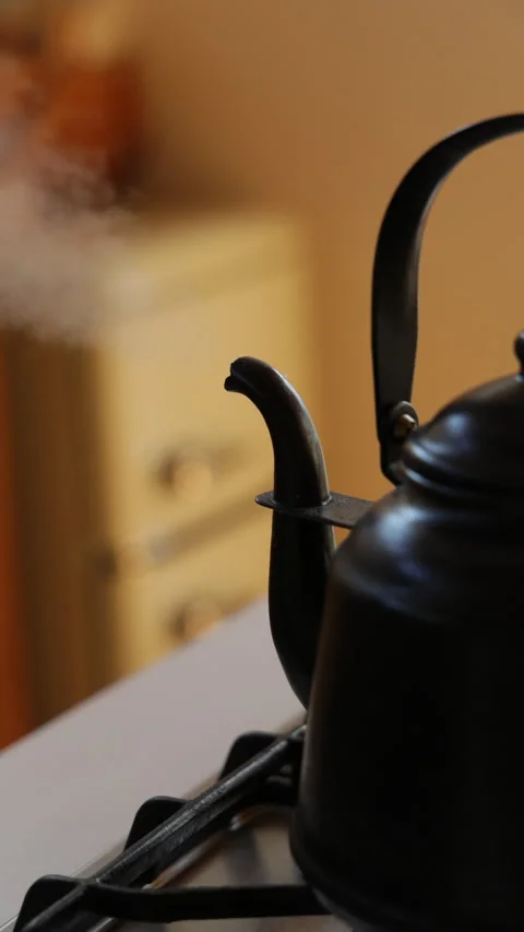 Vertical slow motion close up of a black kettle heating water in Japan Video stock 348159892