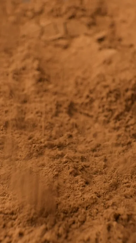Vertical slow motion of cocoa powder falling onto a heap Stock Footage 335836133