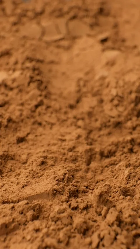 Vertical slow motion of cocoa powder falling onto a heap Stock Footage 336781580