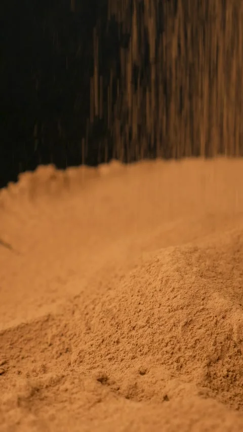 Vertical slow motion cocoa sprinkle on black background Stock Footage 334873162