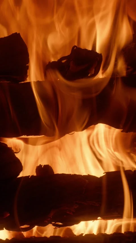 Vertical Slow Motion of Fire Burning Between Two Rows of Wood Logs Stock Footage 328833741