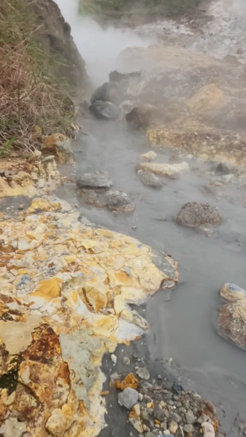 Vertical Slow motion flow of hot mud and sulfur steam in the crater area Stock Footage 319908339