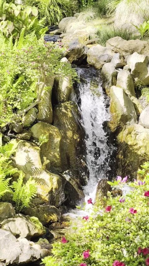 Vertical Slow Motion Garden Waterfall Rocks 4K HDR Stock Footage 333627384