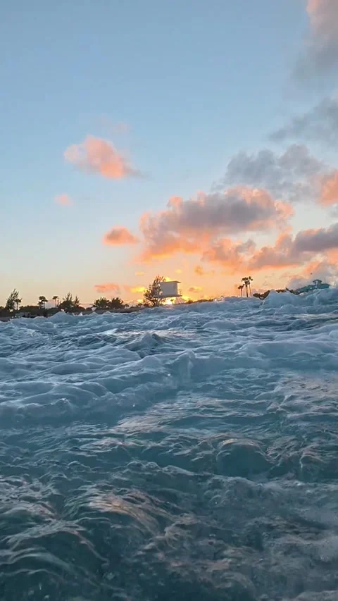 Vertical Slow Motion: Golden Hour Waves Crushing on a Florida Shore at Sunset Stock Footage 329553611