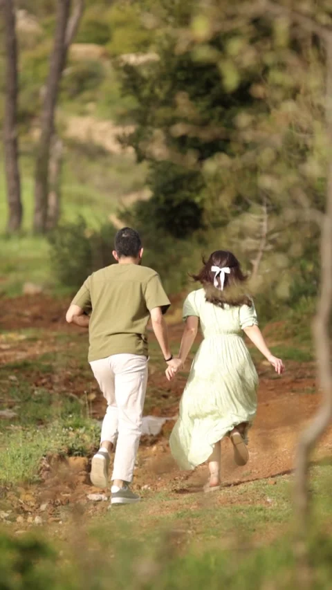 Vertical Slow Motion of Happy Couple Running in the Woods Stock Footage 288855860