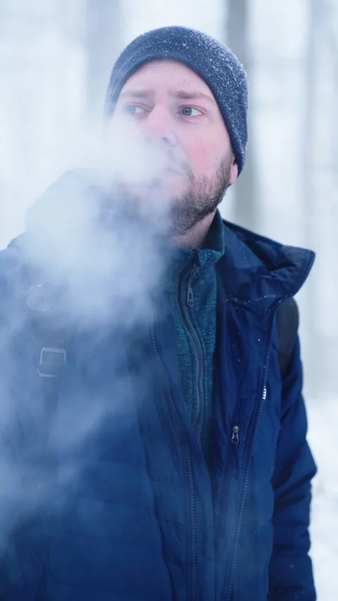 Vertical Slow Motion Man Vaping Outdoors in Winter Stock Footage 331144629