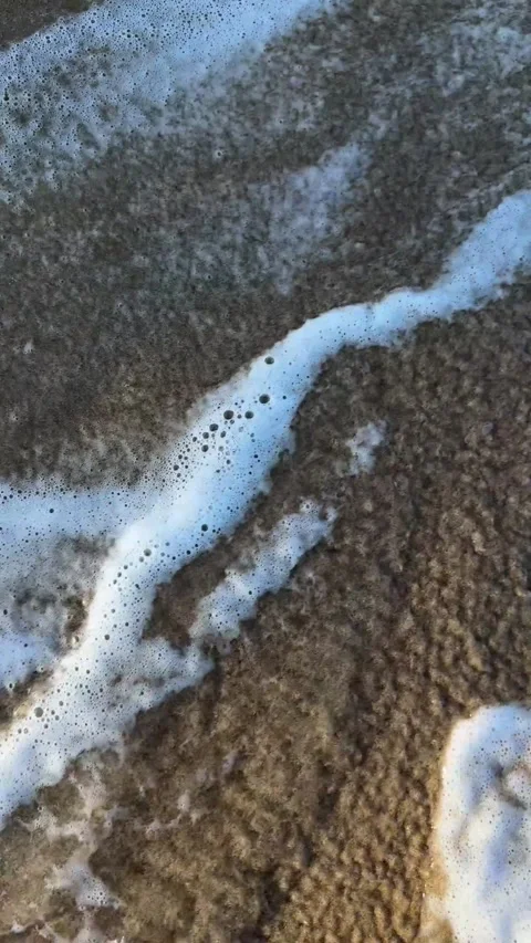 Vertical - Slow Motion Ocean Waves Washing Away Footprints on Sand Stock Footage 330844627
