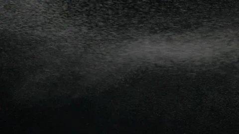 Vertical slow motion of powder, dust, snow particle floating on black background Stock Footage 140831567