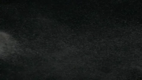 Vertical slow motion of powder, dust, snow particle floating on black background Stock Footage 145245234
