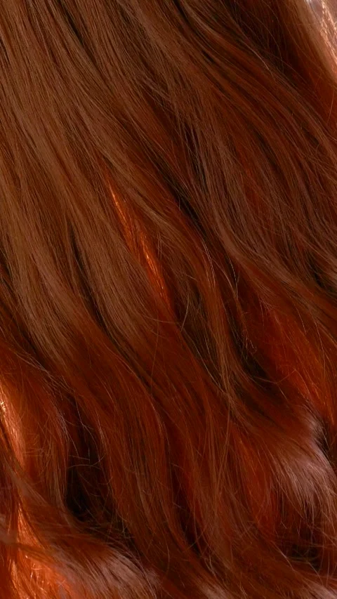 Vertical slow motion red curly hair texture, female brown long hair background Stock Footage 287283373