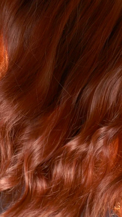 Vertical slow motion red curly hair texture, female brown long hair background Stock Footage 291773494