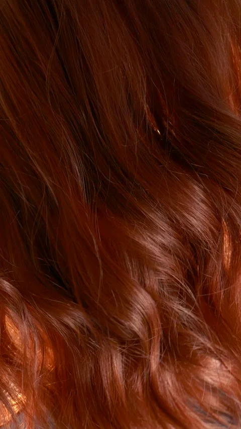 Vertical slow motion red curly hair texture, female brown long hair background Stock Footage 294292458