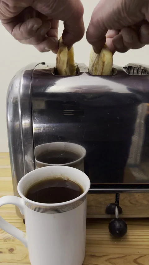 Vertical - Slow motion shot of a hand using a traditional manual steel toaster. Video stock 299993370