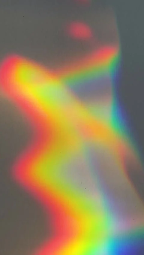 Vertical slow motion shows rainbow prism creating wavy pattern Stock Footage 265618313