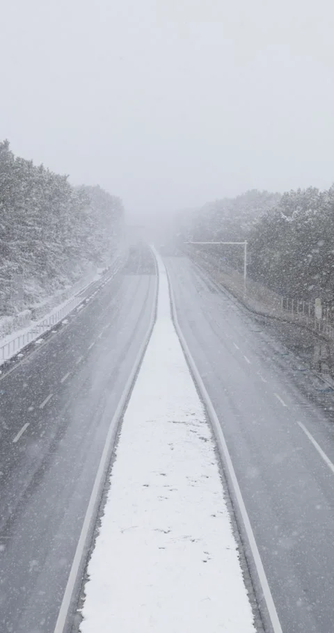 Vertical slow motion snow covered road in town in Japan Video stock 348216935