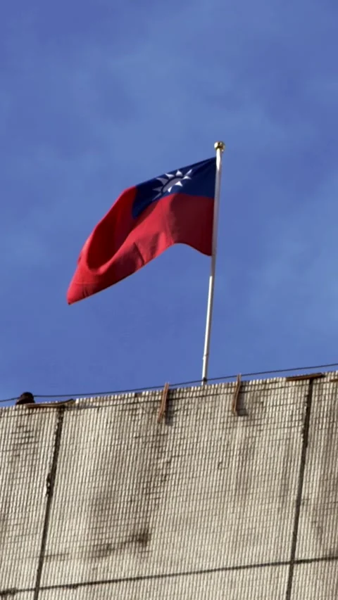 Vertical Slow motion of Taiwan flag waving on rooftop Stock Footage 307571585