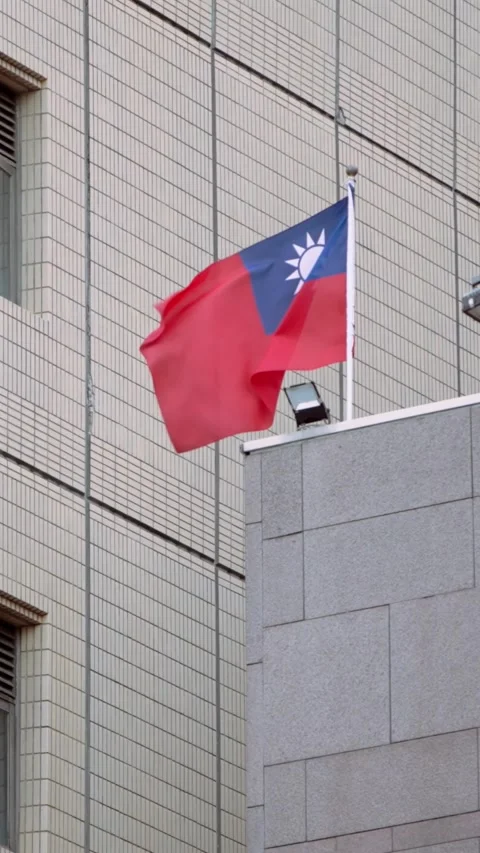Vertical Slow motion of Taiwan flag waving atop city building Stock Footage 316700246