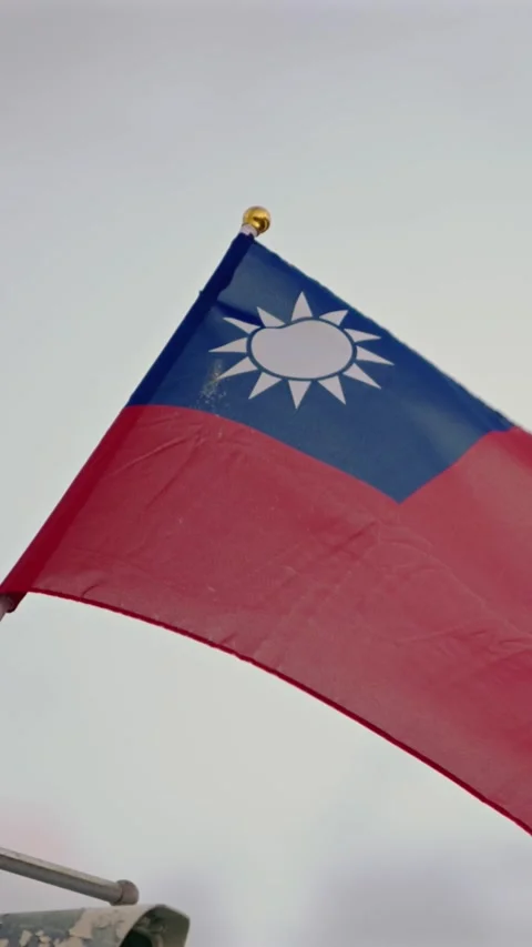 Vertical Slow motion of Taiwan flag waving gracefully against light clouds Stock Footage 318671760