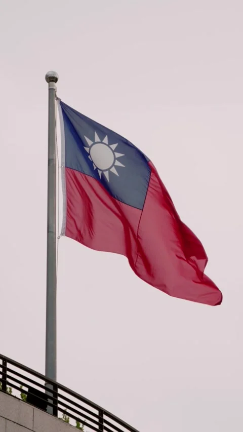 Vertical Slow motion of Taiwan flag waving atop a modern building Stock Footage 318671792
