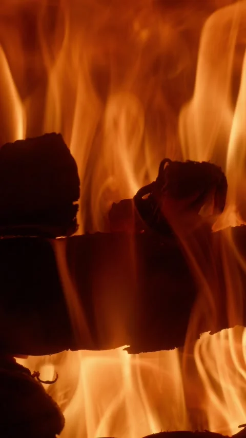 Vertical Slow Motion of Vibrant Fire Flames and Burning Wood Texture Video stock 328833825