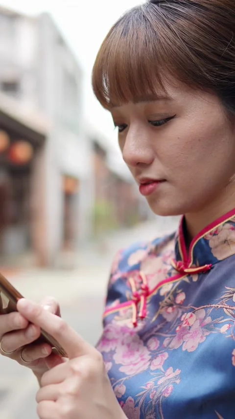A vertical slow-motion video shows a woman in her 20s Stock Footage 275130062