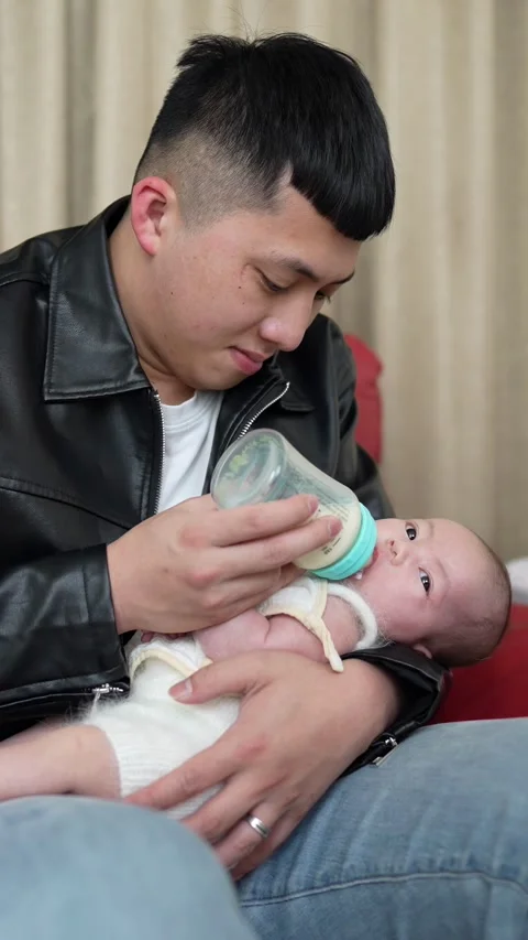 Vertical slow motion video of a Taiwanese mother and father Stock Footage 274374205
