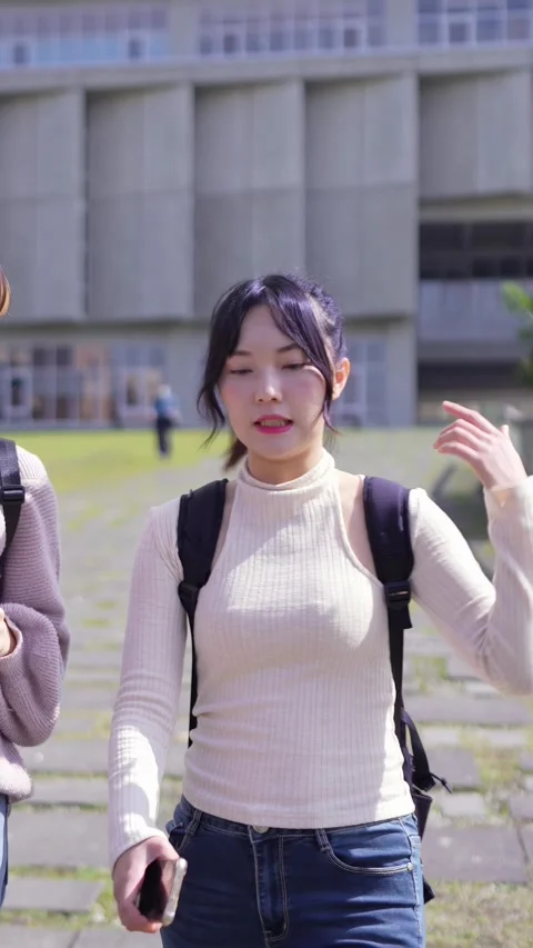 A vertical slow-motion video of two young Taiwanese female college students 動画素材 266362078