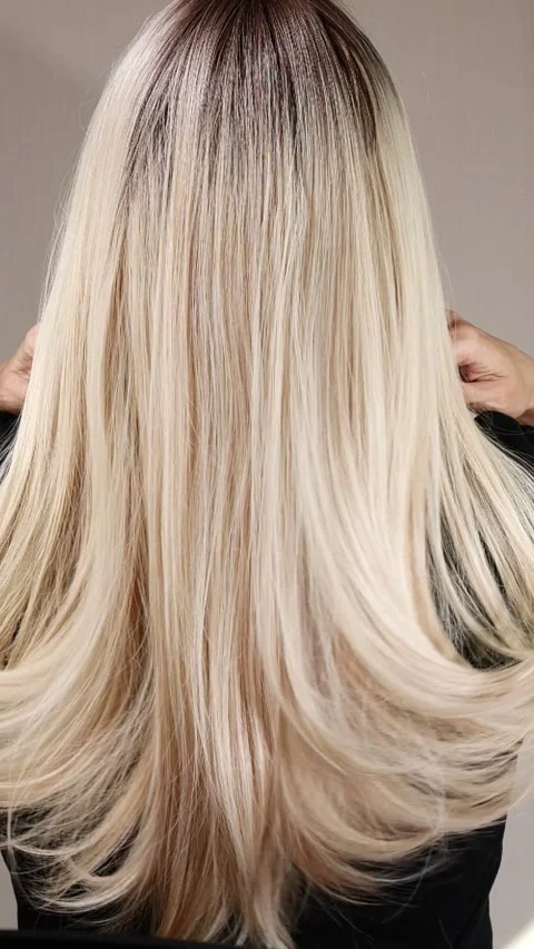 Vertical slow motion video of unrecognizable model with long blond straight hair Stock Footage 281315762