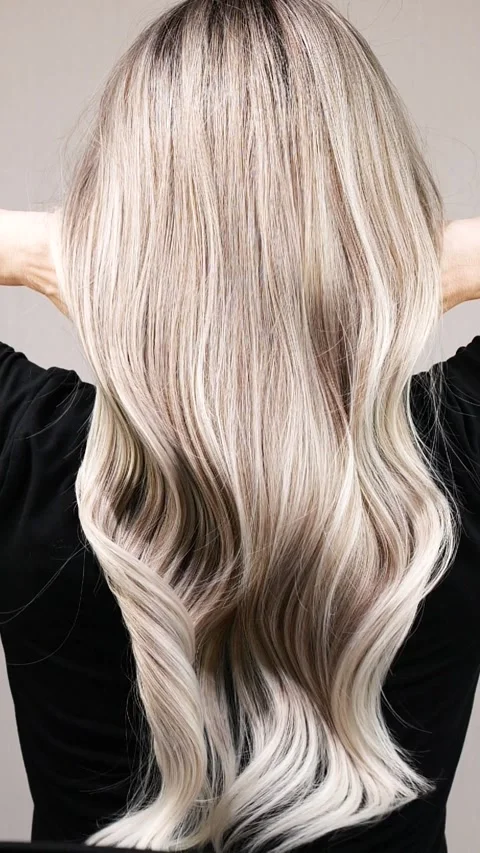 Vertical slow motion video of unrecognizable model with long blond straight hair Stock Footage 287977922