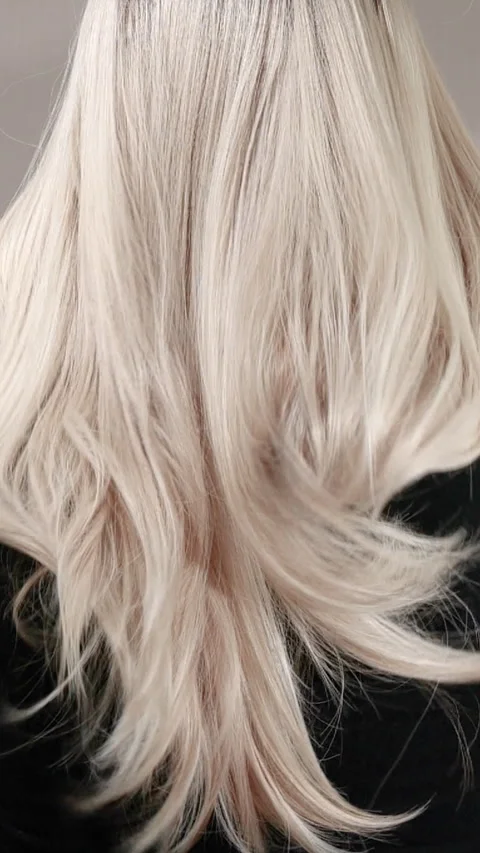 Vertical slow motion video of unrecognizable model with long blond straight hair Stock Footage 289175752