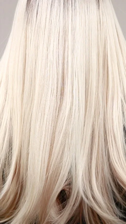 Vertical slow motion video of unrecognizable model with long blond straight hair Stock Footage 289804046