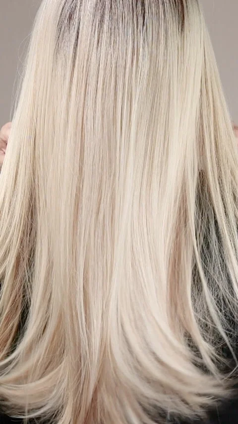 Vertical slow motion video of unrecognizable model with long blond straight hair Stock Footage 291016295