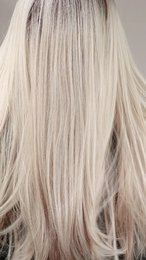 Vertical slow motion video of unrecognizable model with long blond straight hair Stock Footage 316036890