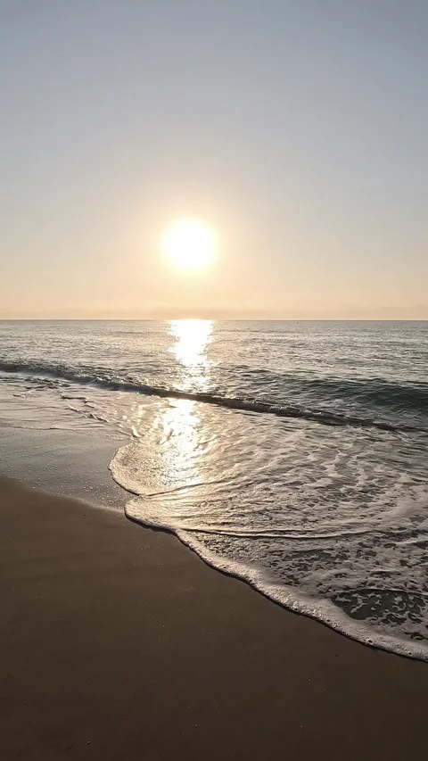 Vertical slow motion video walking the seaside watching the sunrise Stock Footage 296489055