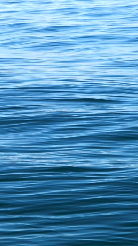 Vertical slow motion of the waves with ripples on the blue water surface of the 스톡 동영상 292217284