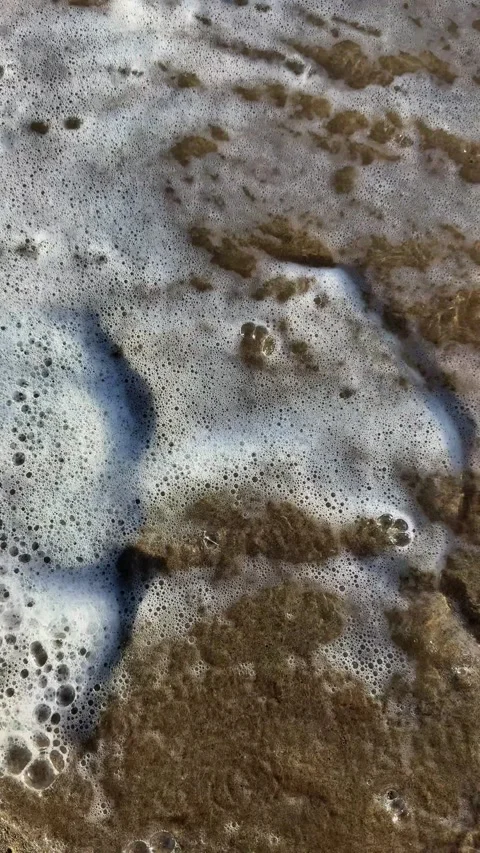 Vertical Slow Motion Waves Washing Away Footprints on Sand Stock Footage 330702727