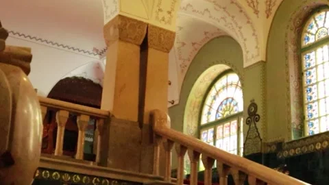 Vertical Slow Pan Left of Historic Carved Staircase and Stained Glass Window Stock-Footage 330369389