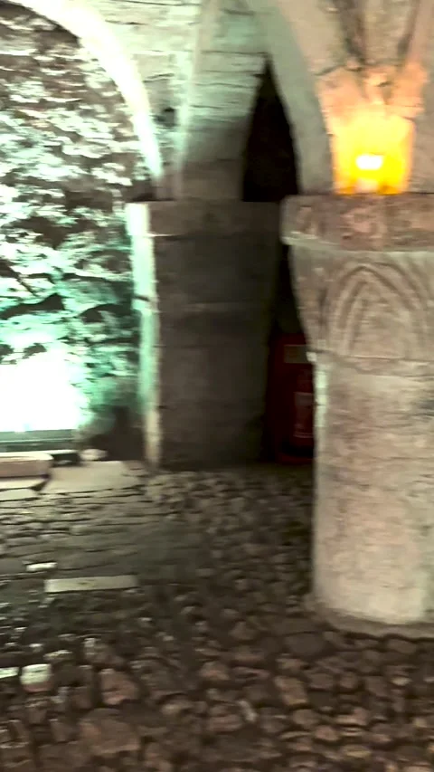 Vertical Slow Pan Through 11th Century Norman Romanesque Crypt with Carved Stock Footage 324835933