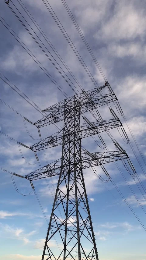 Vertical Slow Push In Toward High Voltage Power Transmission Tower Stock Footage 329894898