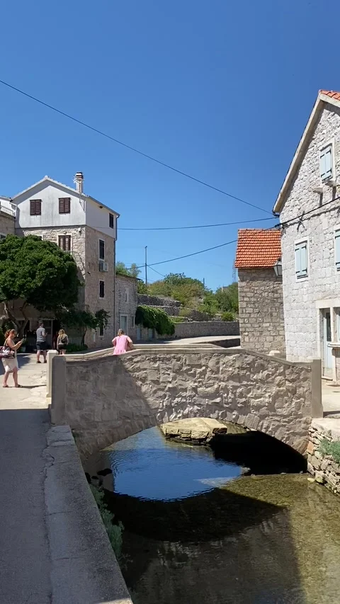 Vertical - Small Stone Bridge Canal Traditional Houses Vrboska Hvar Stock-Footage 345278065