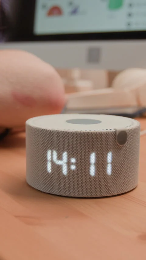 Vertical of Smart Speaker with Voice Assistant Displaying Time on Desk Stock Footage 340774102