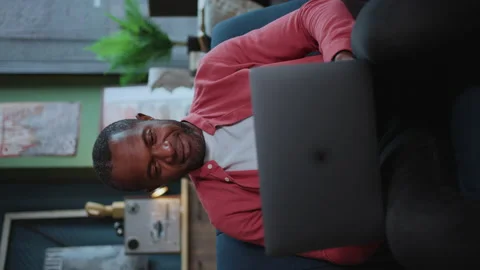 Vertical smartphone size shooting of friendly-looking African man wearing casual Stock Footage 238749885