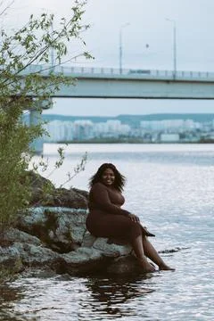 Vertical smiling barefoot bit overweight curly African American multiracial Stock Photos