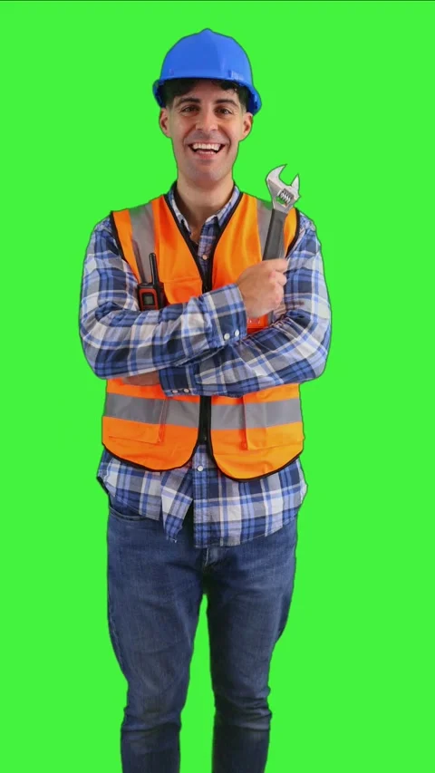 Vertical Smiling construction worker holding a wrench while wearing an oran.. Stock Footage 287327977