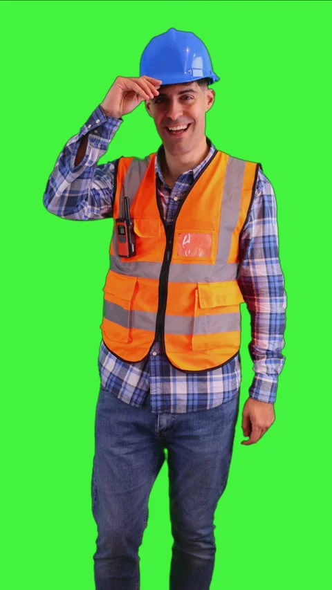 Vertical Smiling construction worker putting on safety helmet, wearing oran.. Stock Footage 287327953