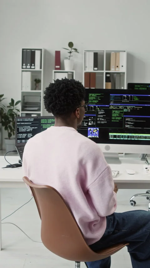 Vertical of Smiling Young Black IT Engineer Posing at Computer Desk in Office Stock Footage 330124777