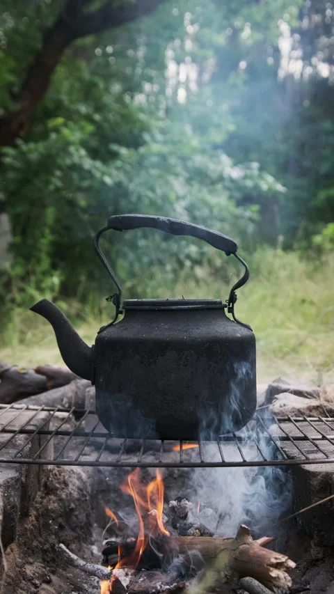 Smoked Tourist Kettle On Camp Fire Stock Photo, Picture and