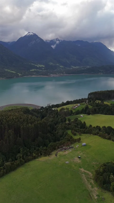 Vertical Smooth Aerial Glide Over Lush Cochamó Valley Toward Fjord and Peaks 動画素材 326078546